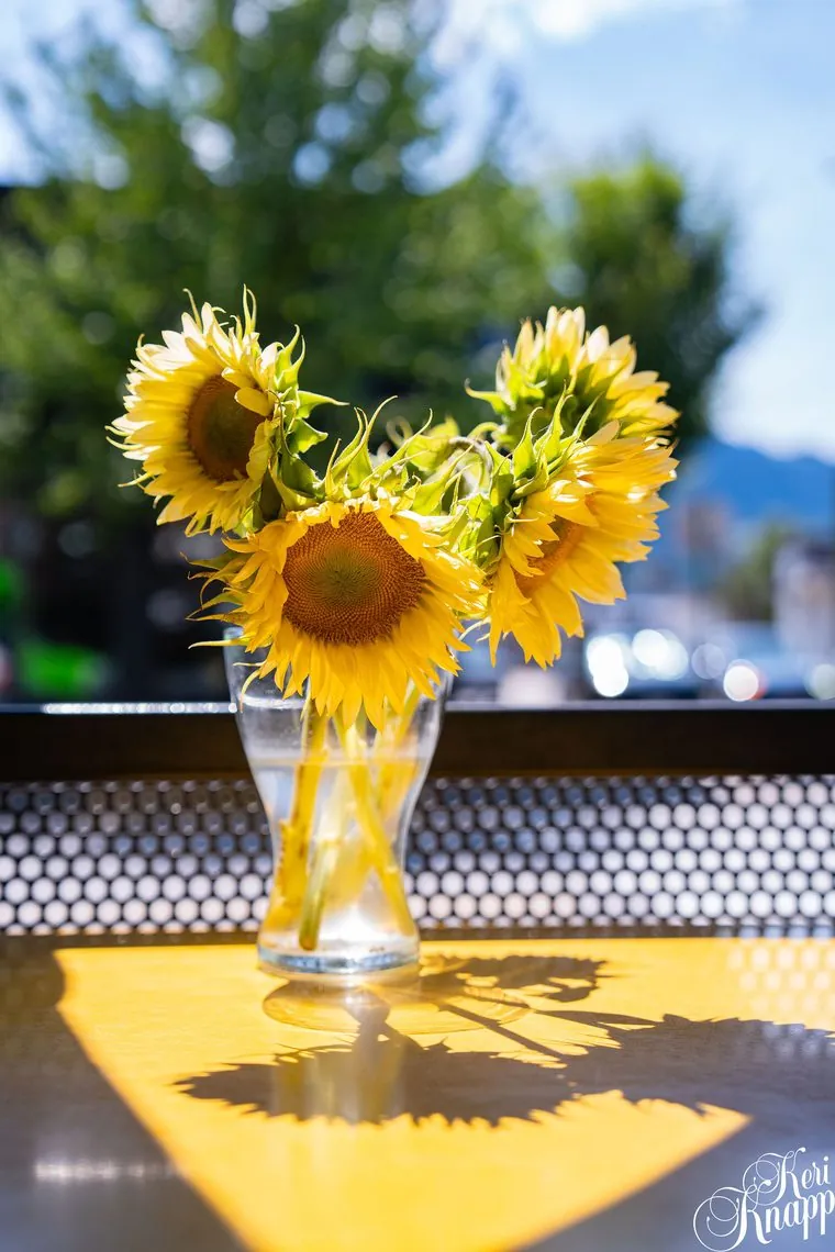 Sunflowers on a patio table at Paramjit's Kitchen