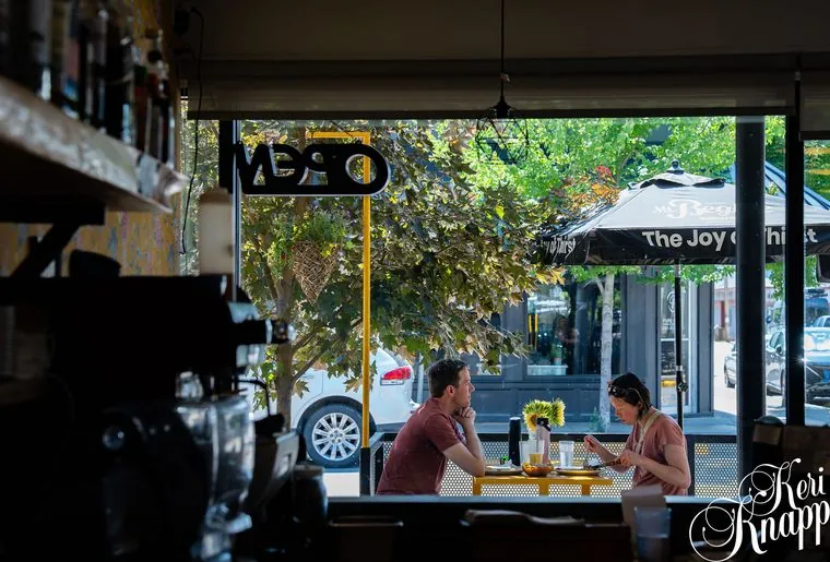 Guests dining on the patio, storefront view